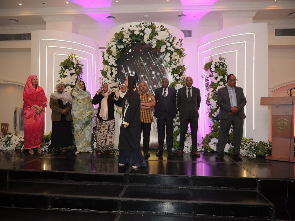 Kibeida school leaders and senior teachers gathered on stage at a school celebration